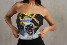 Load image into Gallery viewer, Person wearing a strapless top with a graphic design of a biblically accurate angel with multiple eyes and a yellow halo.