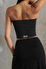 Load image into Gallery viewer, Person wearing a black waist trainer with a visible brand logo against a neutral background