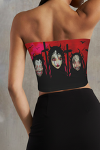 Load image into Gallery viewer, Person wearing a strapless bandeau tubetop with a graphic design of menazing faces and crosses on a red background.